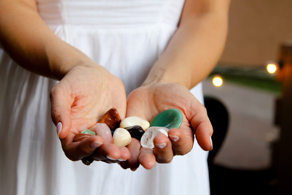 tumbled crystals in hands